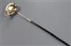 An 18th century white metal toddy ladle, the bowl inset with Queen Anne silver half crown, 38cm.                                       