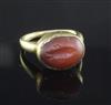 A small yellow metal ring, possibly Roman, set cabochon carnelian carved with a fish,                                                  