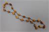 A single strand amber bead and chain link necklace, gross weight 25 grams, 74cm.                                                       