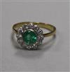 A modern 18ct gold, emerald and diamond circular cluster ring, size N.                                                                 