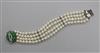 A modern multi strand cultured pearl bracelet with 14 ct white gold and jadeite clasp, 18 cm approx.                                   