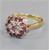 An 18ct gold, ruby and diamond flower head cluster ring, size P.                                                                       