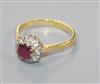 A modern 18ct gold, ruby and diamond cluster ring, size P/Q.                                                                           