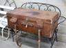 An early 20th century large tan leather trunk with labels, length 100cm, depth 53cm, height 39cm                                                                                                                            