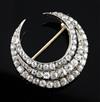 An early 20th century gold and silver, triple row diamond set crescent pendant brooch, 29mm.                                           