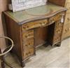 A mahogany serpentine kneehole desk W.91cm                                                                                             