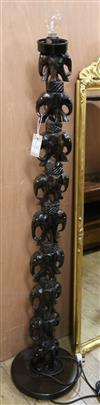 An African carved hardwood standard lamp Width of base 30cm                                                                            