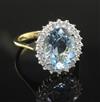 A modern 18ct gold, aquamarine and diamond oval dress ring, size O.                                                                    