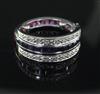 A white gold, ruby, sapphire and diamond set triple band swivel ring, size J.                                                          