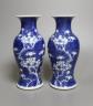 A pair of early 20th century Chinese prunus blue and white baluster form vases, 16 cms high.                                                                                                                                