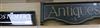 A glass "Post Office" sign and a wooden "Antiques"                                                                                     