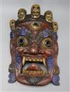 A Tibetan carved wood mask length 44cm approx.                                                                                         