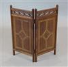 A Victorian Gothic revival inlaid oak small two fold fire screen, H.2ft 1in.                                                           