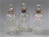 A pair of silver collared dimple moulded glass decanters and another with plated mount                                                 