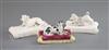 Three Minton porcelain figures of recumbent dogs on tasselled cushions, c.1831-40, L. 10.3cm - 12.2cm, spaniel restored                