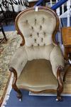 A Victorian mahogany-framed armchair with scrolled terminals, deep-buttoned beige upholstery                                           