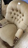 A Victorian mahogany-framed low armchair with scrolled terminals, deep-buttoned beige upholstery                                       
