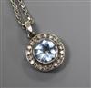 An 18ct white gold, diamond and blue paste circular pendant on 18ct white gold chain.                                                  