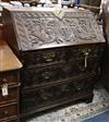 A carved oak bureau W.95cm                                                                                                             