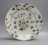 An English polychrome delftware charger, 33cms diameter.                                                                                                                                                                    