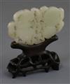 A Chinese pale celadon jade plaque, 19th century, 8.4cm, wood stand                                                                    