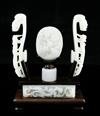 A collection of Chinese archaistic pale celadon jade belt fittings and a white jade archer's ring, 17th-19th century,