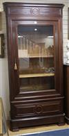 A 19th century French "plum pudding" mahogany bookcase, enclosed by a single glazed door W.115cm                                       