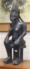 A Yoruba ebonised wood figure of a seated woman height 70cm                                                                            