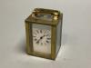 A brass cased miniature timepiece, height 6cm excluding handle.                                                                                                                                                             