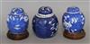 A Chinese ginger jar and cover decorated with prunus and a similar smaller pair of ginger jars on hardwood bases                       