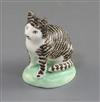 A rare Lowestoft porcelain figure of a seated tabby cat, c.1780, H. 6cm, ears restored                                                 