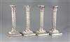 A set of four Victorian silver wrythen pillar candlesticks, 26.4cm.                                                                    