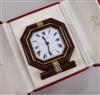 A Must de Cartier gilt metal and lacquer cased travelling quartz alarm clock, in fitted Must de Cartier case.                          