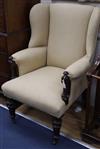 A Victorian rosewood upholstered wing armchair                                                                                         