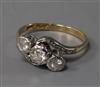 An 18ct gold and platinum, three stone diamond crossover ring, size N.                                                                 