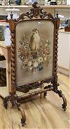 A Victorian carved walnut firescreen with needlework panel of a falcon W.68cm H.133cm                                                  