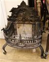 A Gothic style cast iron fire grate, the scroll back decorated with a Bagot goat jumping a fence, W.63cm                               