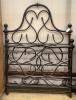 A wrought iron single bed frame, width 117cm                                                                                                                                                                                