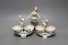 Two 19th century German porcelain putti salts and a Sampson Hancock, Derby figurine holding a shell (3) - tallest 17.5cm                                                                                                    