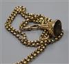 A Victorian 9ct gold guard chain hung with a yellow metal overlaid gem set fob seal,                                                   