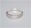 A white metal and twin row diamond set half hoop ring, size O.                                                                         