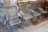 A set of six weathered teak folding garden armchairs and a low teak garden table                                                                                                                                            