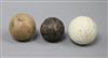 A white colonel dimple pattern golf ball and two other vintage golf balls                                                              