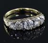 A late Victorian gold and graduated five stone diamond half hoop ring, size M.                                                         