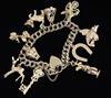 A 1960's 9ct gold charm bracelet, hung with ten assorted charms, gross 57 grams.                                                       