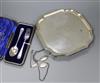 A shaped square silver presentation salver, a cased two-piece Christening set, two silver identity bracelets and a plated bracelet     