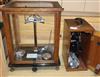 A set of balance scales and a cased "Beck" microscope                                                                                  