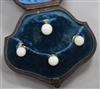 A cased early 20th century four piece yellow metal and white opal dress stud set.                                                      