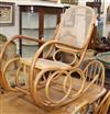 A caned bentwood rocking chair                                                                                                         