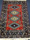 A Caucasian design red ground rug 180 x 126cm                                                                                          